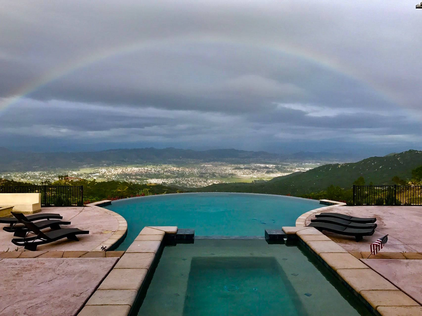 GoldMine Realty infinity pool with rainbow view